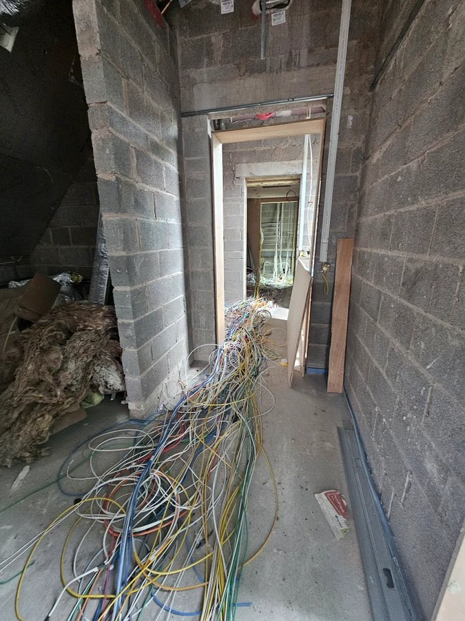 First-fix cabling running through the building shell.