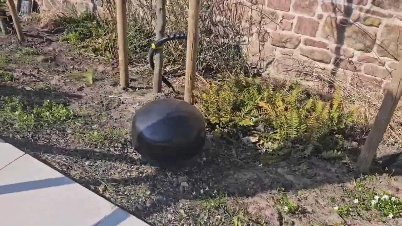 Sonance garden speakers among planting beside a patio