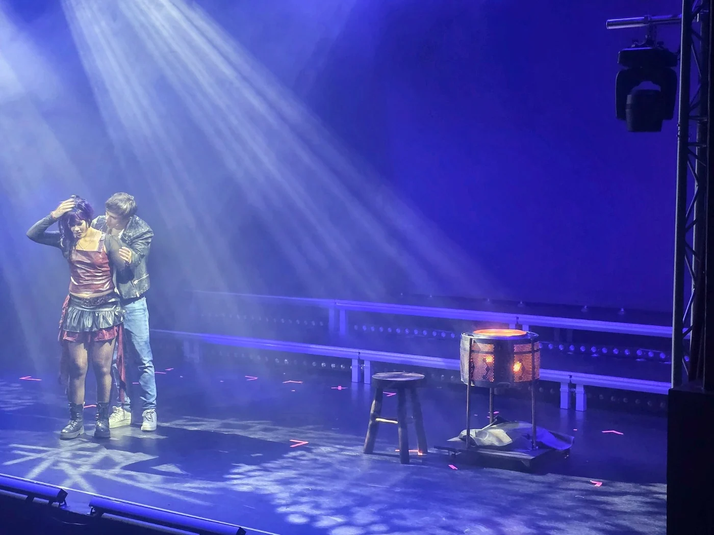 The cast of Made for Stage UK Ltd’s We Will Rock You on stage, with the illuminated firepit built by InControl